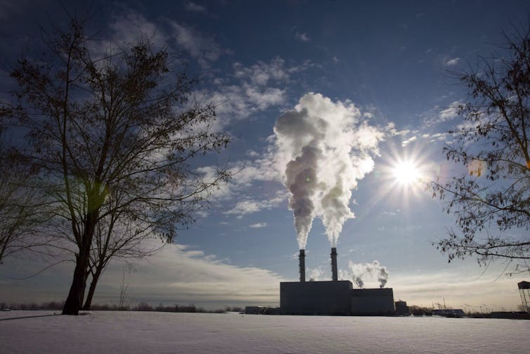 Smoke rises into the air amidst a clear sky.