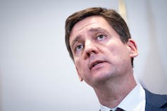 A man with short dark hair.