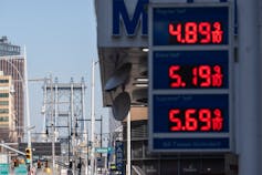 A digital display showing gas prices at a gas station